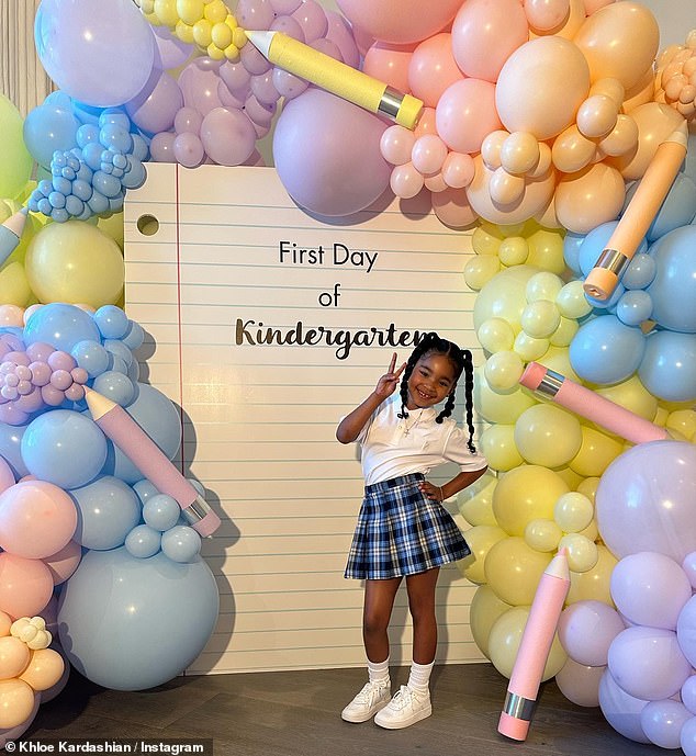 Очаровательно: основательница The Good American также поделилась фотографиями, на которых она позирует с Тру на коленях, когда они улыбаются, фотографируясь перед роскошной аркой из воздушных шаров и надувных цветных карандашей.
